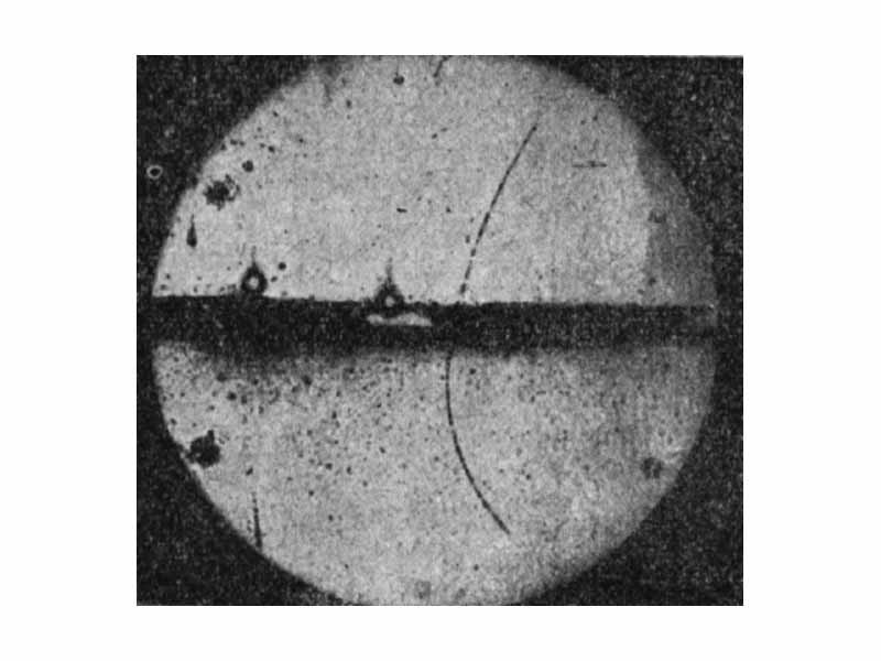 A new particle is discovered: The first detection of the positron occurred in 1932 in a cloud chamber built by Carl D. Anderson. The track of the positron can be seen, going from top to bottom and curving to the right.