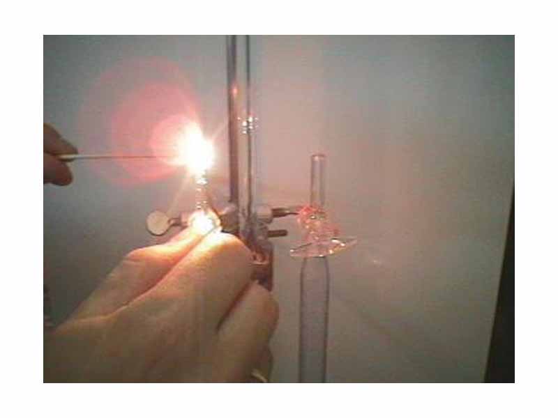 A brightly glowing ember, indicating oxygen is detected in the collecting tube.