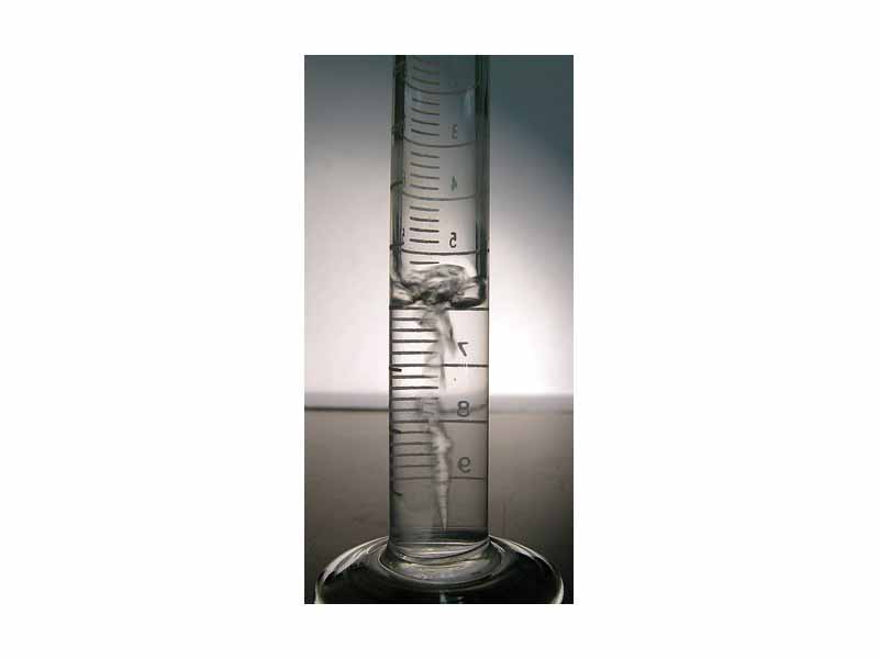 Boiling liquid tetrafluoroethane in a small graduated cylinder.